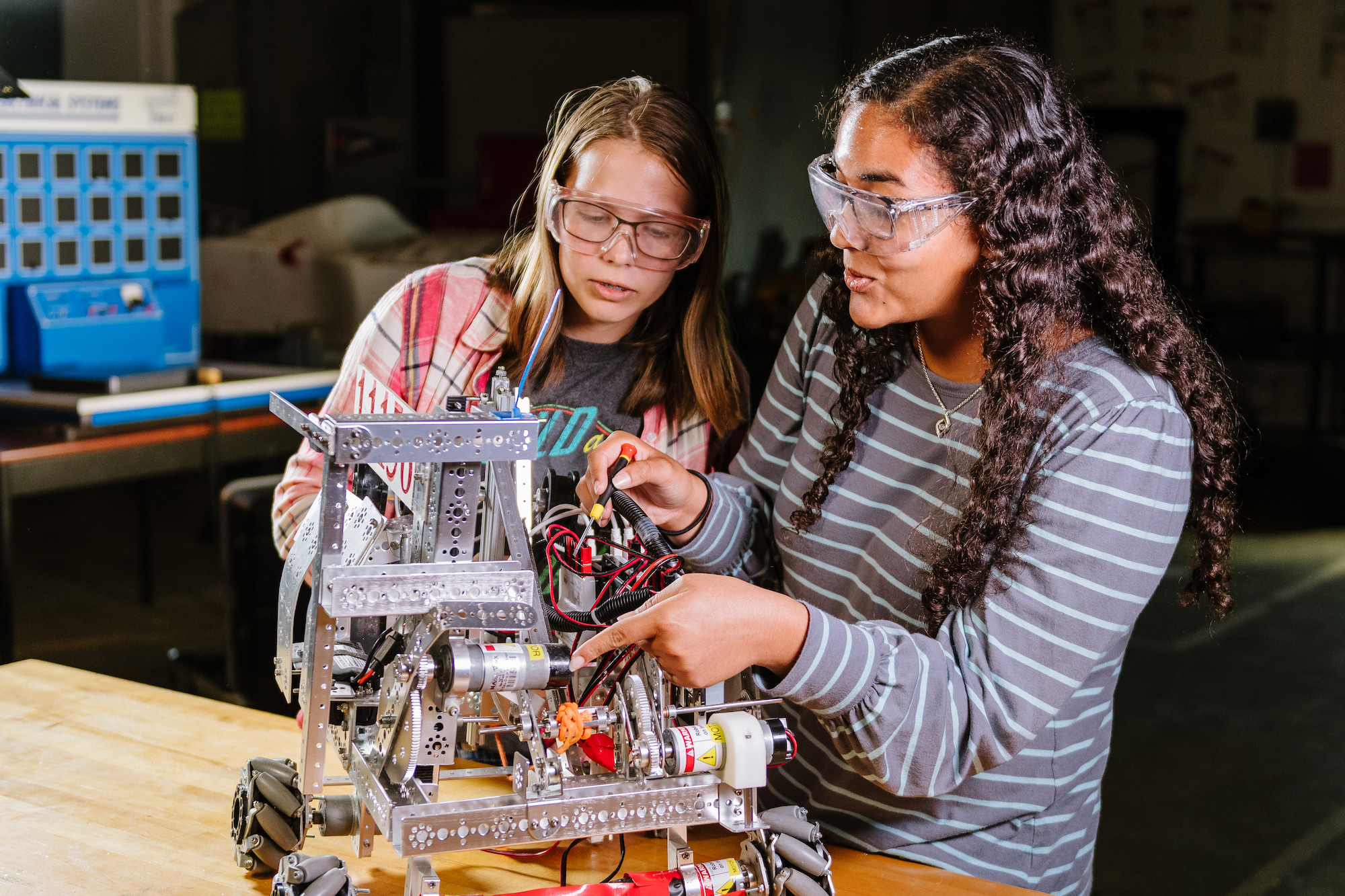 Two girl engineering students building a project